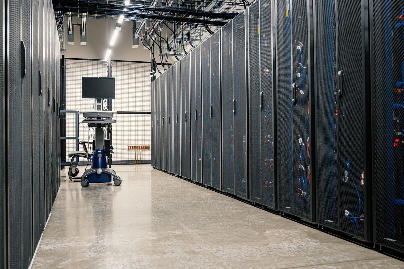 Rows of server cabinets in a bright, modern data center